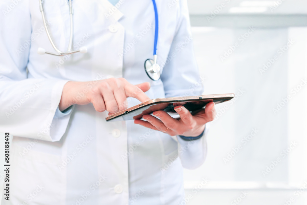 Woman doctor works with data in her tablet computer Woman doctor works with data in her tablet computer