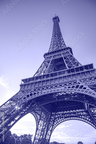 Wide angle shot of Eiffel Tower, Paris, France in a very peri color - color of the year 2022