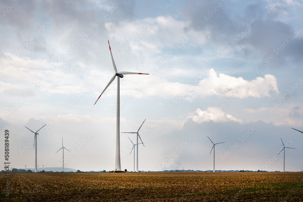 Crops with windmills and power plant on the horizon. Crops with windmills and power plant on the horizon.