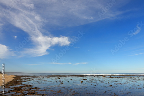 A view over the coastline at Witsand  South Africa  with white clouds and blue skies.