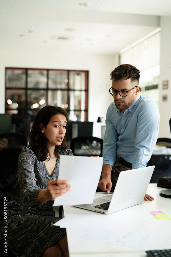 Colleagues in office. Businesswoman and businessman discussing work in office.. Colleagues in office. Businesswoman and businessman discussing work in office..