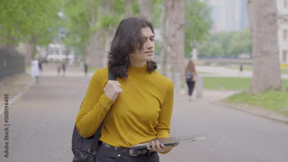 Tracking Shot of Young Student Walking Through Park Tracking Shot of Young Student Walking Through Park