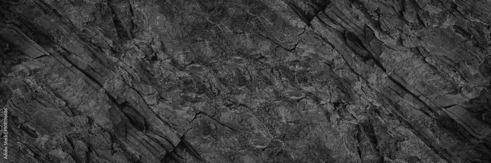 Obraz premium Black white rock texture. Rough mountain surface. Close-up. Stone background with space for design. Web banner. Wide. Panoramic.