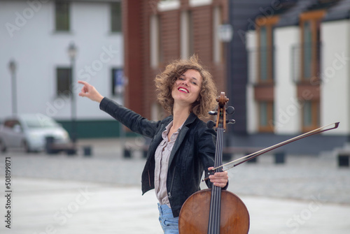 A female musician with a cello on the street photo