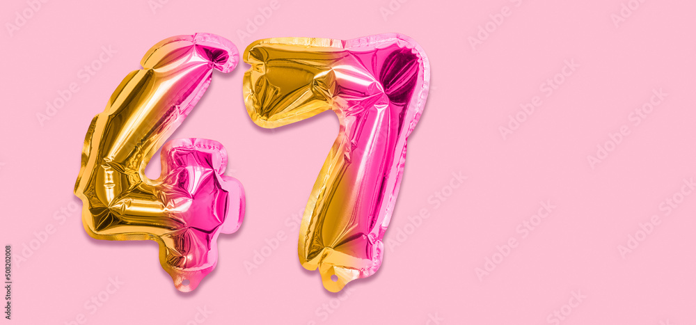 Rainbow foil balloon number, digit forty seven on a pink background. Birthday greeting card with inscription 47. Top view. Numerical digit. Celebration event, template. Banner Rainbow foil balloon number, digit forty seven on a pink background. Birthday greeting card with inscription 47. Top view. Numerical digit. Celebration event, template. Banner