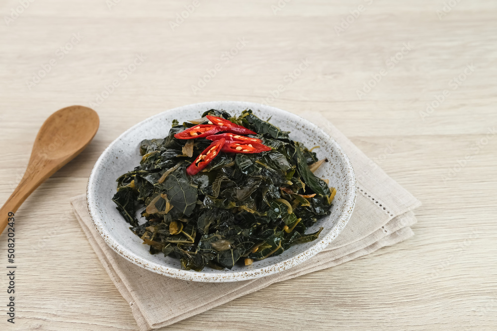 Stir Fry Papaya Leaves or Tumis Daun Pepaya, a traditional Indonesian dish made from boiled papaya leaves stir-fried with spices and chilies.
Stir Fry Papaya Leaves or Tumis Daun Pepaya, a traditional Indonesian dish made from boiled papaya leaves stir-fried with spices and chilies.