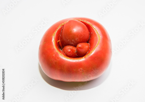 A strange shape of a ripe tomato in the form of hemorrhoids