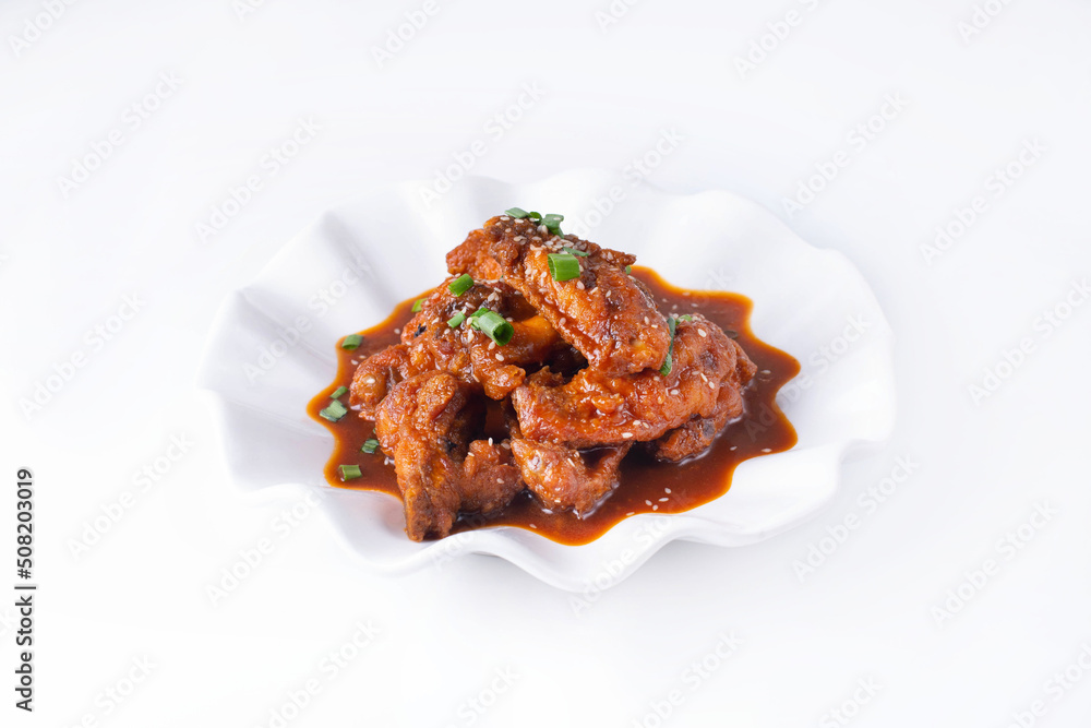chicken wings with oyster sauce in a white plate on a white background
