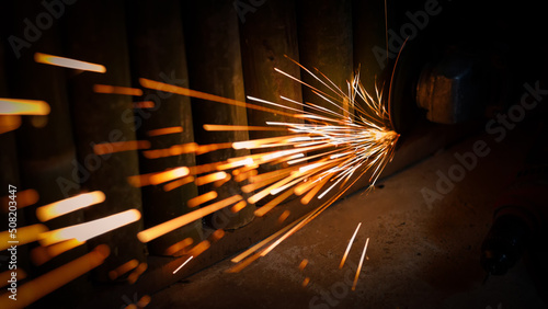 Flying sparks from an angle grinder being used at night