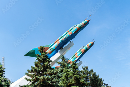 Two MiG-21MF planes on pedestal against blue autumn sky. Close-up. Two combat supersonic aircraft were installed on pedestal in early 80s of last century. Krasnodar, Russia - May 31, 2022 photo