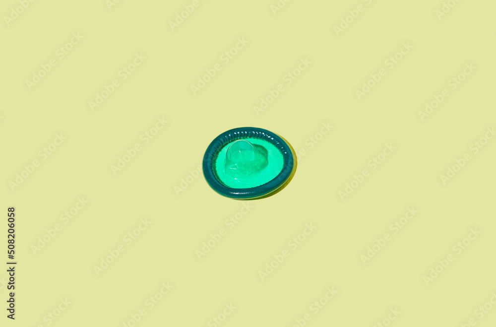 Minimal shot of single condom on pastel background safe sex and protection concept, copy space Minimal shot of single condom on pastel background safe sex and protection concept, copy space