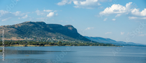 landscape of houses on a mountain and a large dam