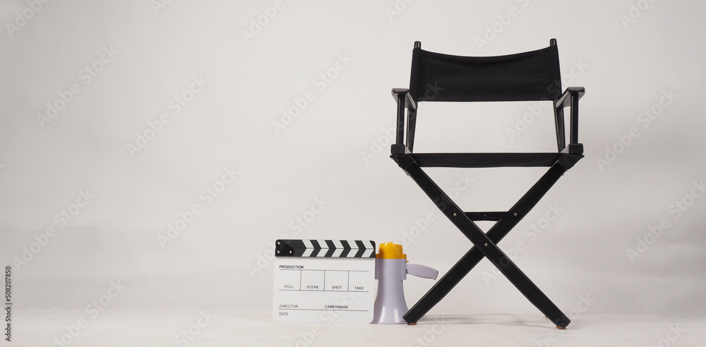 Black director chair and white clapper board or movie slate and megaphone on white background.. Black director chair and white clapper board or movie slate and megaphone on white background..
