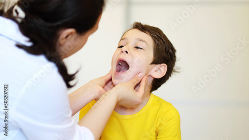 Doctor examining child. Laryngologist, a child with a doctor. The boy in the office of a pediatrician, medical examination