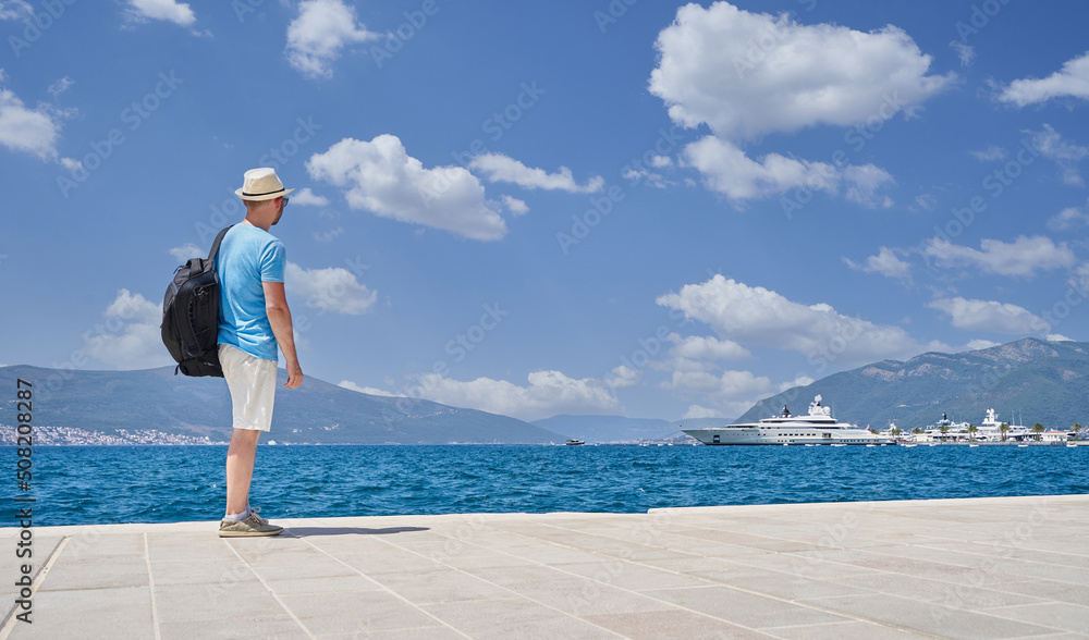 Male tourist looks at the sea in Montenegro, travel concept