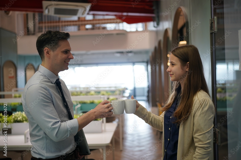 Young man consulting his business partner at meeting in office Young man consulting his business partner at meeting in office