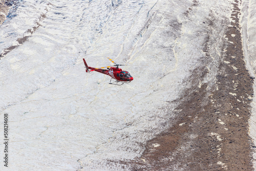 Helicopter flying over the snowy Swiss Alps in Switzerland