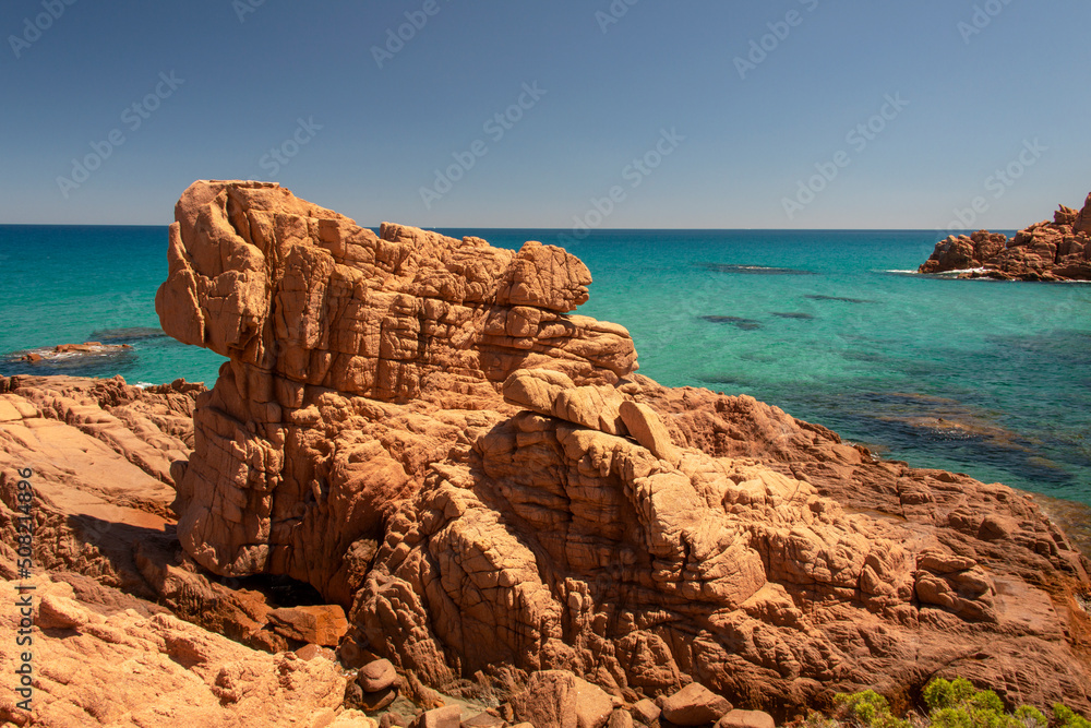 Su Sirboni beach, Sardinia. Marina di Gairo. Crystal clear waters with white sand and red rocks and junipers