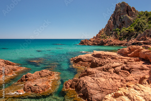 Su Sirboni beach, Sardinia. Marina di Gairo. Crystal clear waters with white sand and red rocks and junipers photo