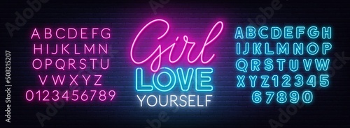 Girl Love Yourself neon quote on a brick wall.