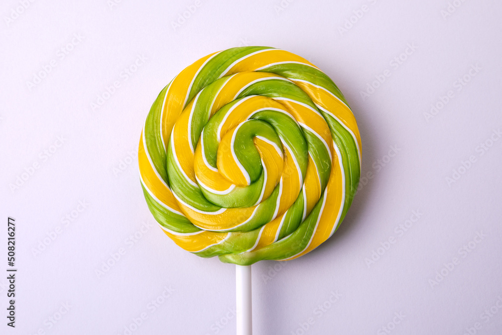 Colored candy on a stick, white background. Sweets and unhealthy diet