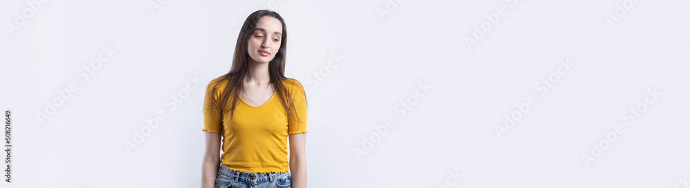 Portrait of a beautiful young woman thinking, isolated on concrete background Portrait of a beautiful young woman thinking, isolated on concrete background
