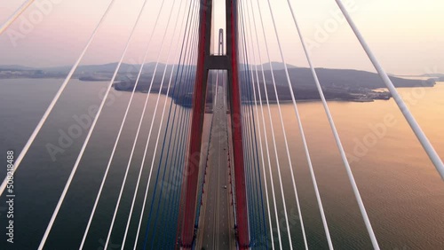 View from above. Russian bridge in Vladivostok across the Eastern Bosphorus. The camera flies between the guys over the roadway.
