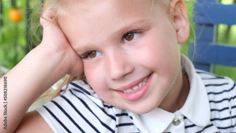 Portrait of cute face of young child girl looking away with happy fun expression and winking. Pretty face with big brown eyes. Sincere emotions. Happy childhood concept. Fun grimace. Portrait of cute face of young child girl looking away with happy fun expression and winking. Pretty face with big brown eyes. Sincere emotions. Happy childhood concept. Fun grimace.