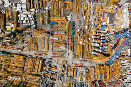Storage place of high-rise cranes. Aerial view of yellow elements, industrial technology.