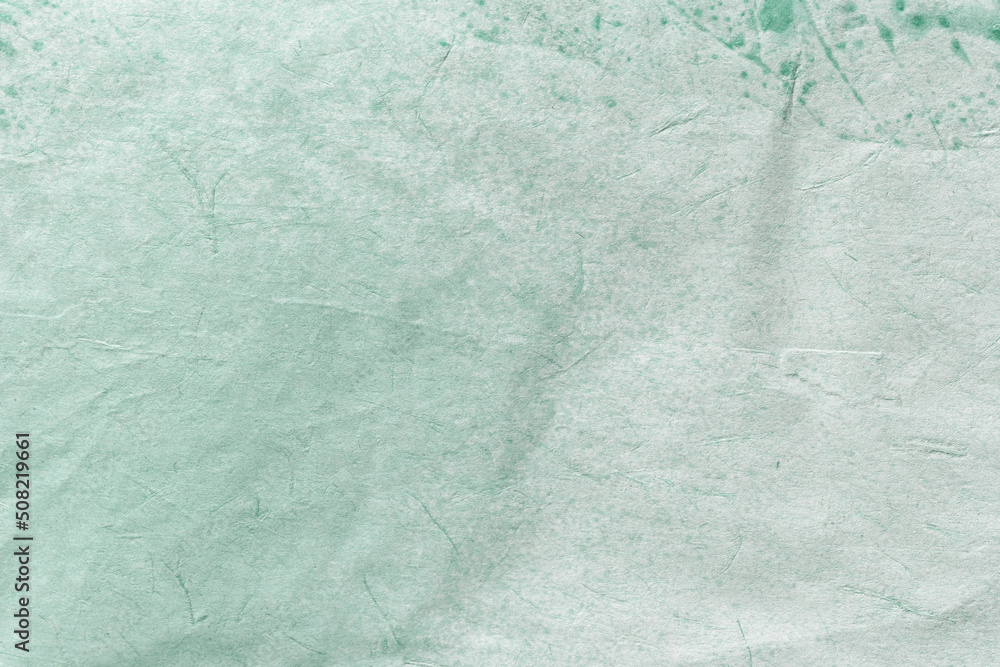 Obraz premium Texture of craft light green old paper, crumpled background. Vintage cyan grunge surface backdrop.