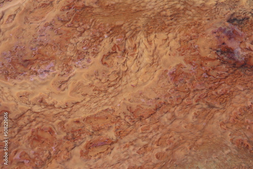 orange precipitate which indicates the water contains iron. form a beautiful background. © Riski