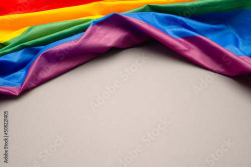 Top view of the rainbow flag or LGBT is on a gray background with copy space