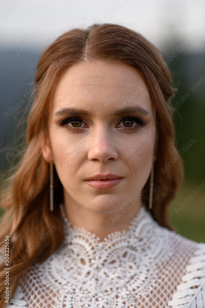 Beautiful bride in a white wedding dress on a background of mountains. Beautiful bride in a white wedding dress on a background of mountains.