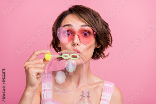 Photo of young girl omg wow face reaction foam playful blow bubbles holiday isolated over pink color background