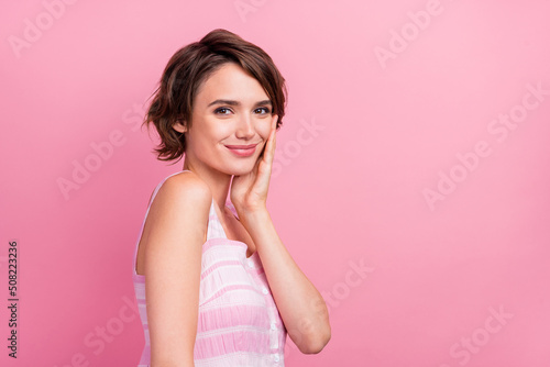 Profile side photo of young adorable girl face care cream salon treatment isolated over pink color background