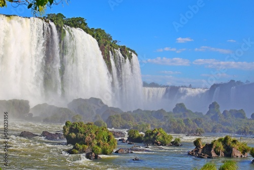 
Foz do Iguaçu Falls in Brazil. Bulky water continuously falling. Fog in the air and vision blurred by fog. International tourism, UN preservation area. photo