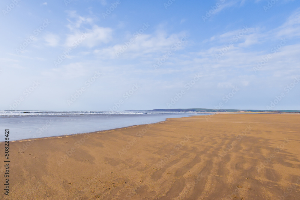 Wide angle view of empty beach with expanse of sand