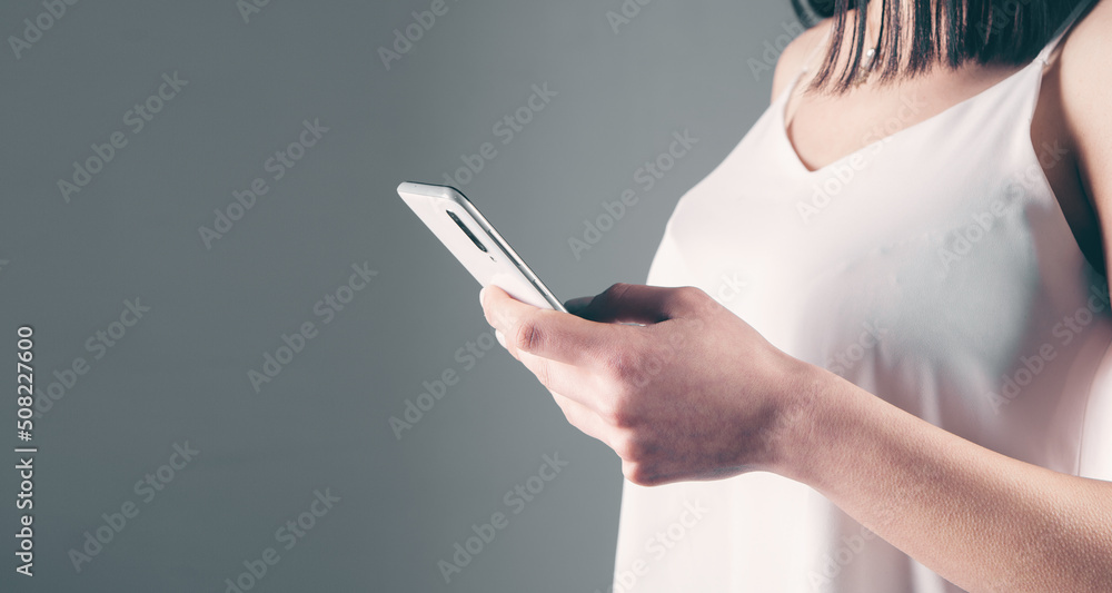 young woman standing with a phone