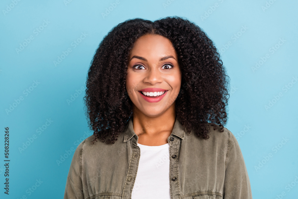 Portrait of satisfied charming young person beaming smile look camera isolated on blue color background Portrait of satisfied charming young person beaming smile look camera isolated on blue color background