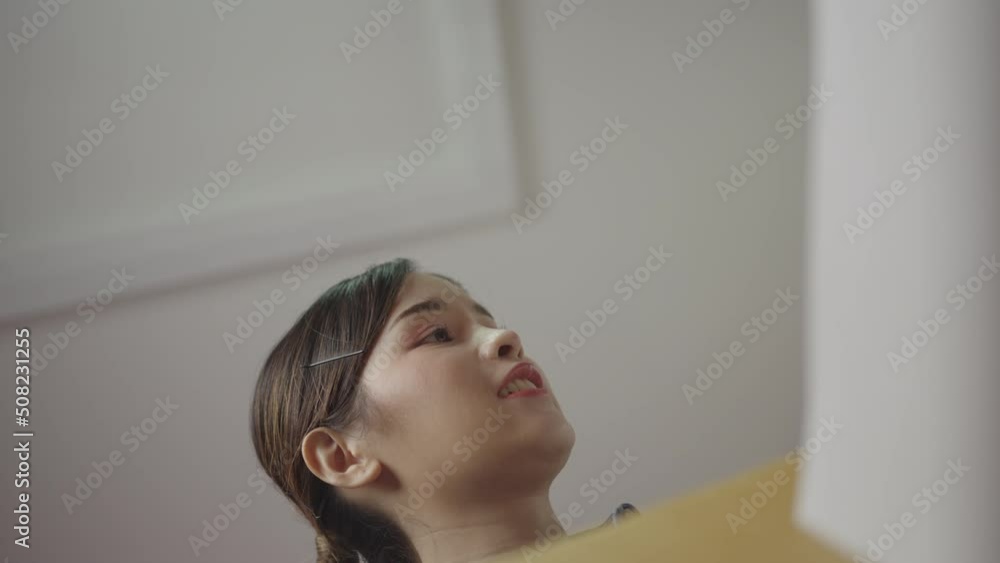 Freelance beautiful Asian woman stores accounting, financial or important documents in brown cardboard boxes. Freelance beautiful Asian woman stores accounting, financial or important documents in brown cardboard boxes.