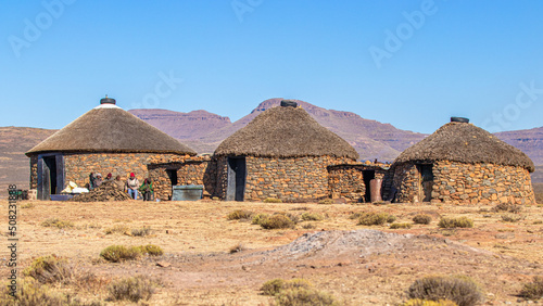 Unidentified Basotho people in front of a rondavel, Lesotho. photo