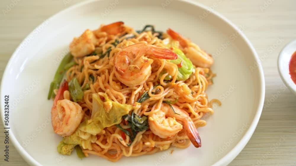 Stir-fried instant noodles sukiyaki with shrimps - Asian food style Stir-fried instant noodles sukiyaki with shrimps - Asian food style