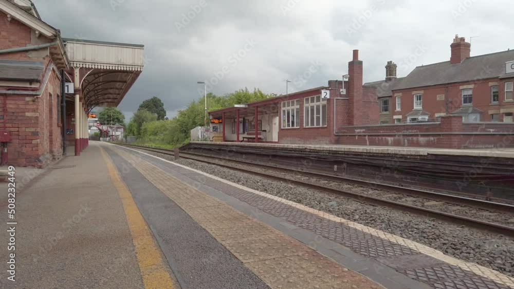 A small rural empty railway station in England under an early evening leaden sky that was threatening to rain. A small rural empty railway station in England under an early evening leaden sky that was threatening to rain.