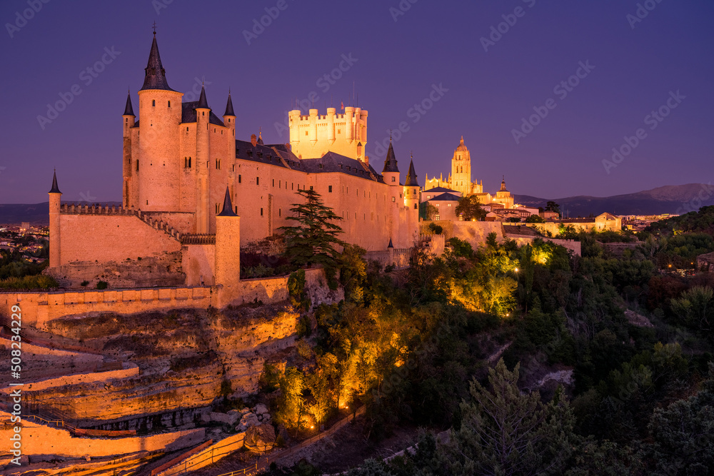 View of the Alcazar fortress and St Mary cathedral of segovia illuminated at night, listed world Heritage centre by UNESCO