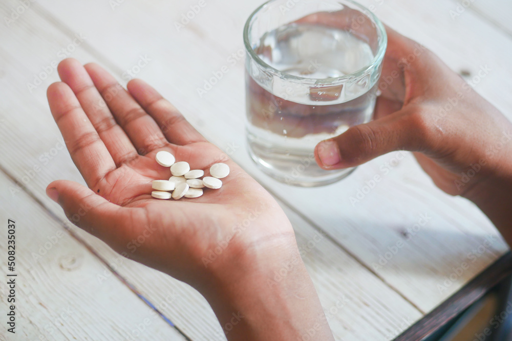 unrecognized man in white shirt taking medicine unrecognized man in white shirt taking medicine