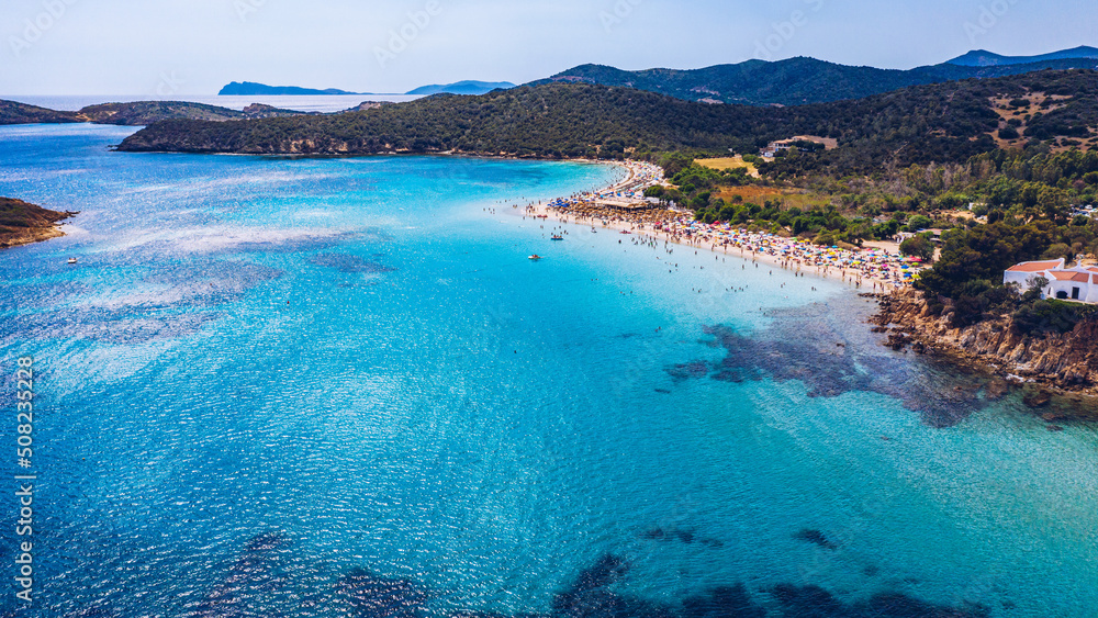 Obraz premium Aerial shot of Tuerredda beach on a beautiful day, Sardinia, Italy. Aerial drone view of Tuerredda in Sardegna. Famous Tuerredda beach on the south of Sardinia near Teulada. Sardinia, Italy.