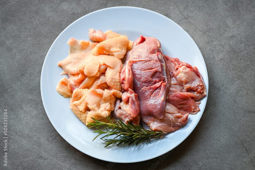 Raw duck breast and duck skin with herb rosemary to cook on plate, Fresh duck meat for food