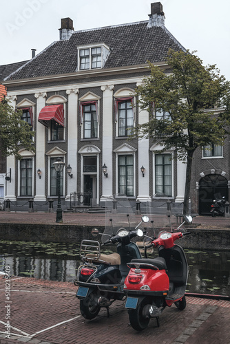 black and red scooter is parked in Leiden