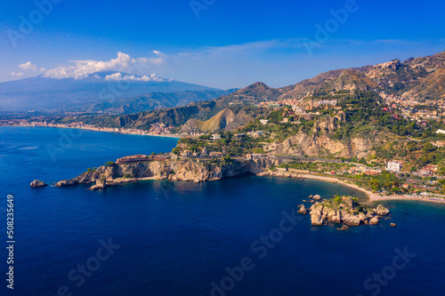 Taormina is a city on the island of Sicily, Italy. Mount Etna over Taormina cityscape, Messina, Sicily. View of Taormina located in Metropolitan City of Messina, on east coast of Sicily island, Italy. photo