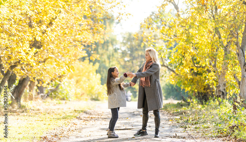 Mom with her daughter during autumn © Angelov
